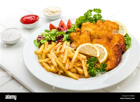 chicken schnitzel with chips and salad Stock Photo - Alamy