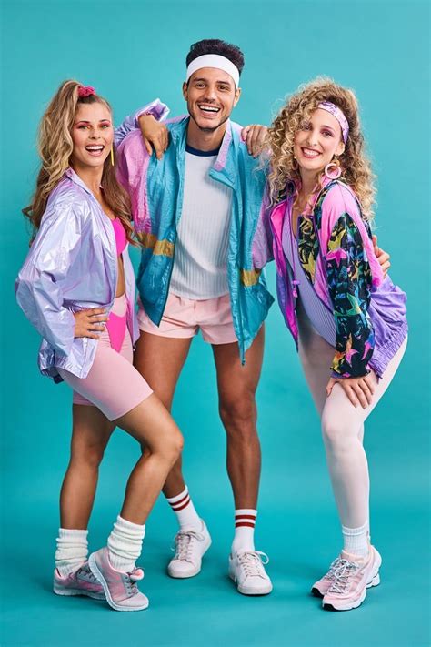 three people are posing for a photo in front of a blue background wearing colorful clothing and ...