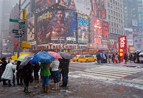 "Times Square Snow" A busy Times square with people during a snow storm. | Times square, Stock ...