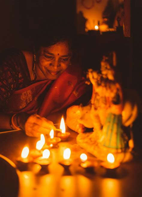 Woman Lighting Diya Oil Lamps · Free Stock Photo