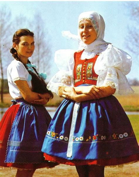 two women dressed in traditional clothing standing next to each other ...