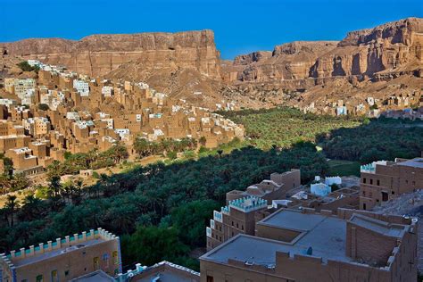 beautiful village with palm trees and mud-brick houses in the wadi Doan, tribal region of ...