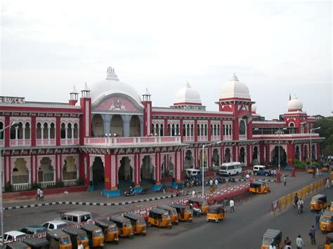 a large building with many cars parked in front of it and people ...