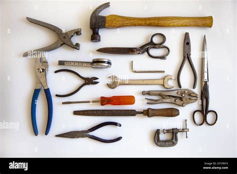 A top view of vintage metalwork tools isolated on a white background ...