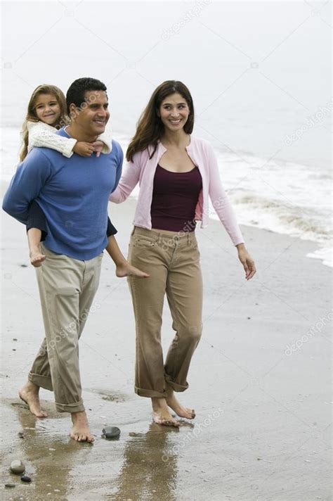 Family walking on beach — Stock Photo © londondeposit #33806431