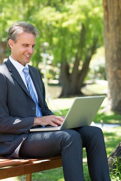 Premium Photo | Businessman using laptop at park