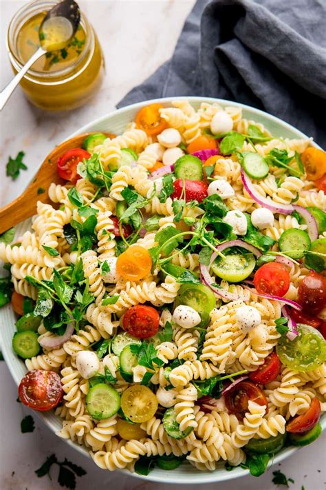 A simple pasta salad with mozzarella and veggies plus an easy Italian dressing. Customize with ...