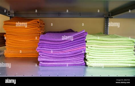 Clean terry soft towels in different colors folded, stacked in a pile. Stacks of towels stacked ...