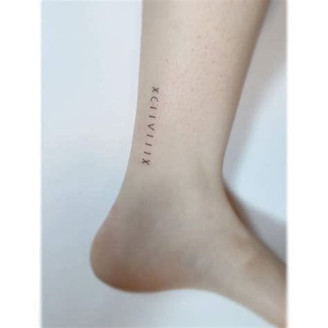 Roman numerals tattooed on the ankle.