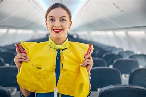 Smiling Cheerful Air Hostess Wearing Life Jacket on Her Shoulder Stock ...