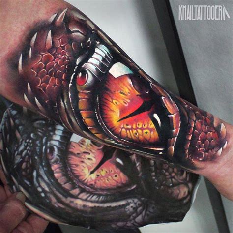 Realistic dragon eye tattoo on the inner forearm.