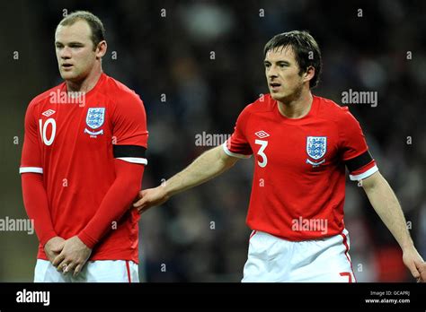 Englands wayne rooney and leighton baines defending a free kick hi-res ...