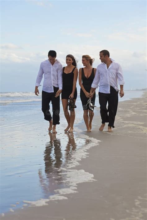 Four Young People, Two Couples, Walking On A Beach Stock Photo - Image of girl, spring: 16401544