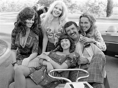 four women and one man are sitting on a cart