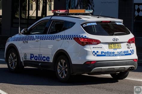 a police car is parked on the side of the road in front of a building