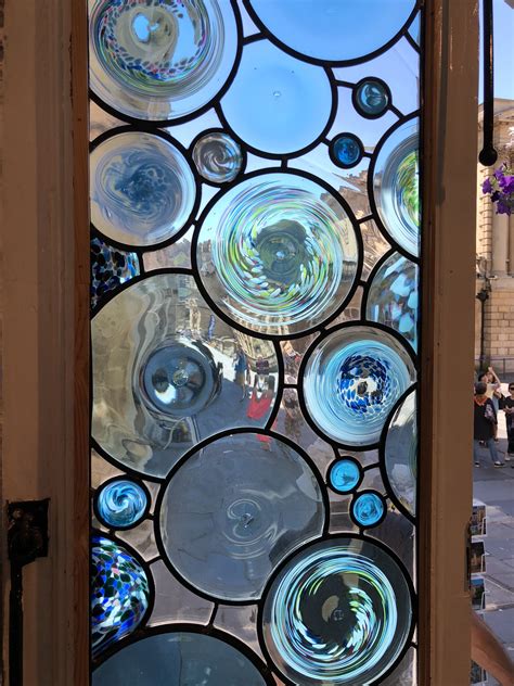 This contemporary stained glass roundel panel, is in the Bath Aqua Glass shop's front door ...