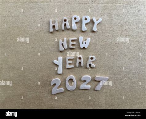 Happy New Year 2027 with wooden letters and numbers Stock Photo - Alamy