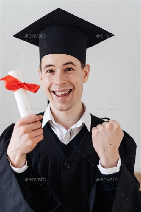 Excited student hot his diploma. Graduation and emotion concept Stock ...