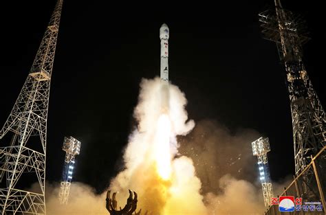 North Korea claims it launched first spy satellite, promises more | Reuters