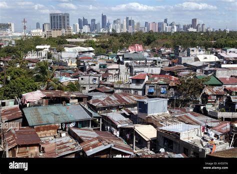 Manila, The Philippines: Slum huts in front of the skyline of the Stock ...