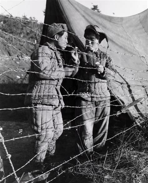 Two Korean prisoners of war enjoy a cigarette. North Korea Tour, Korean Peninsula, Prisoners Of ...