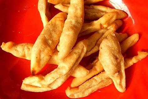 french fries are on a red plate with silverware