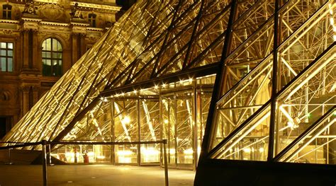 Metal Frame Glass Pyramid Outside a Museum With Yellow Lights during Nighttime · Free Stock Photo
