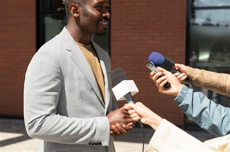 Premium Photo | Journalists taking an interview outdoors