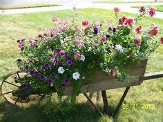 antique wheelbarrows - Bing Images Yard Planters, Wheelbarrow Planter ...