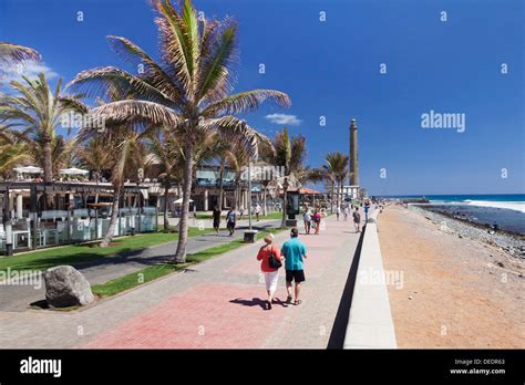 Promenade and lighthouse Faro de Maspalomas, Maspalomas, Gran Stock ...