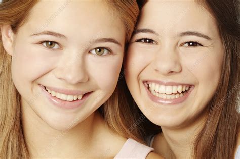 Close up of teenage girls smiling faces - Stock Image - F007/0452 - Science Photo Library