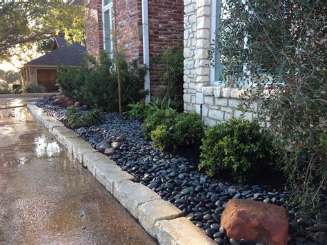 Here we used river rock instead of mulch. Makes for a dramatic look ...