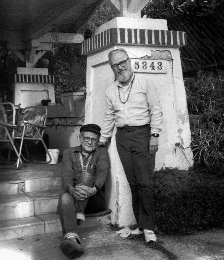 Harry Hay (left), founder of the Mattachine Society, showing off his dress. Undated Photo.