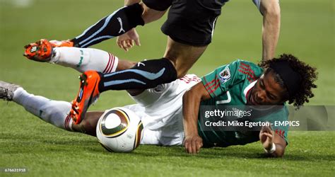 Mexico's Dos Santos Giovani slides into a tackle during the game ...