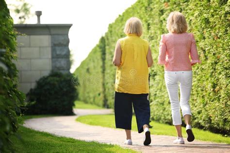 Mature Women Walking in Green Park Stock Image - Image of middleaged, green: 151134189