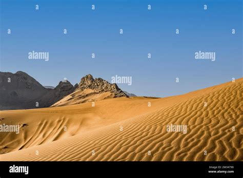 Sand dunes and rocky mountains in the Arabian desert Stock Photo - Alamy