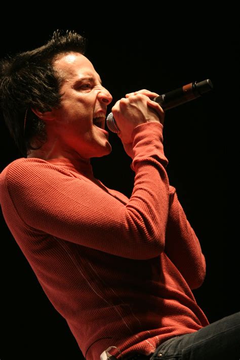 a man singing into a microphone on stage