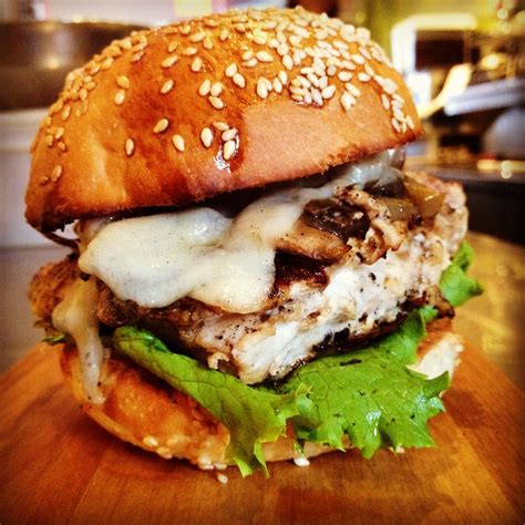 Chargrilled gourmet chicken burger with Swiss cheese, mushrooms and ...