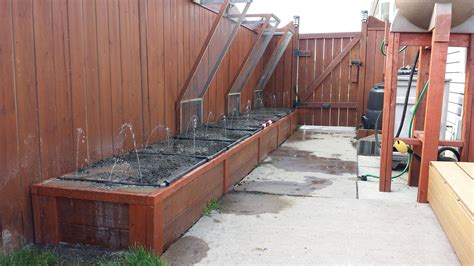 Raise garden bed with irrigation system using water from rain barrel ...