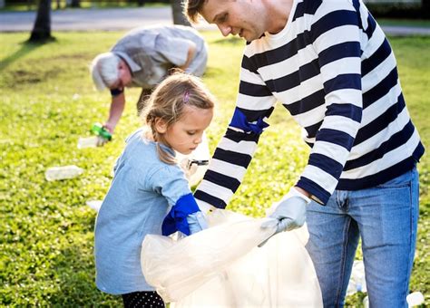 Premium Photo | Kids picking up trash in the park