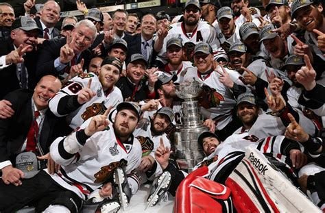 Jonathan Toews Kisses Stanley Cup During Team Championship Photo | HockeyGods