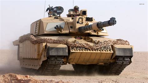 an army tank driving through the desert