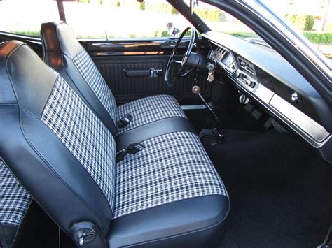 the interior of a car with black and white checkered cloth on it's seat ...