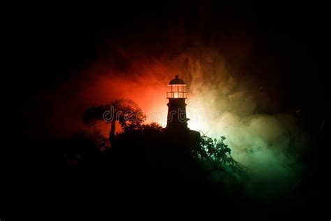 Lighthouse with Light Beam at Night with Fog. Old Lighthouse Standing ...