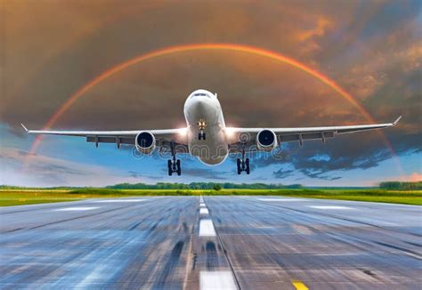 Passenger Airplane Landing at Sunset Rainbow on a Runway. Stock Photo - Image of background ...