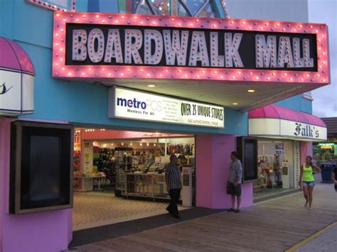 the entrance to boardwalk mall with people walking in front and onlookers milling about