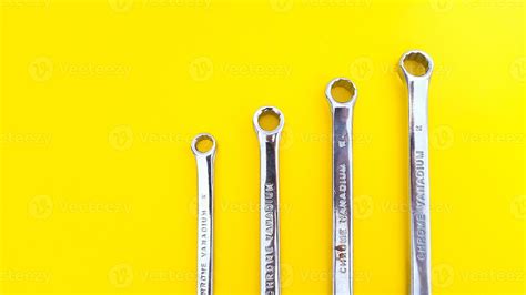 Various sizes of wrench or spanner isolated on yellow background. Mechanical Tool. 19080531 ...