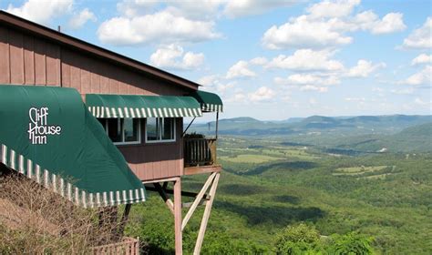 a building with awnings on top of it overlooking the valley and mountains in the distance