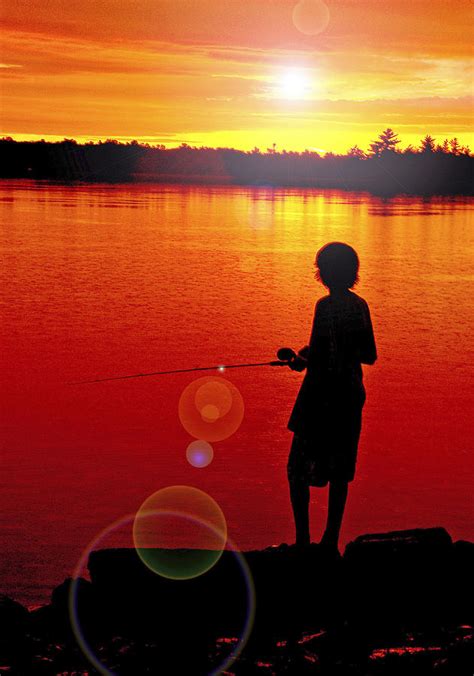 Silhouetted Boy Fishing at Sunset Photograph by A Macarthur Gurmankin