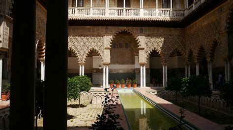 Sevilla alcázar architecture building. A courtyard with a pool in the ...